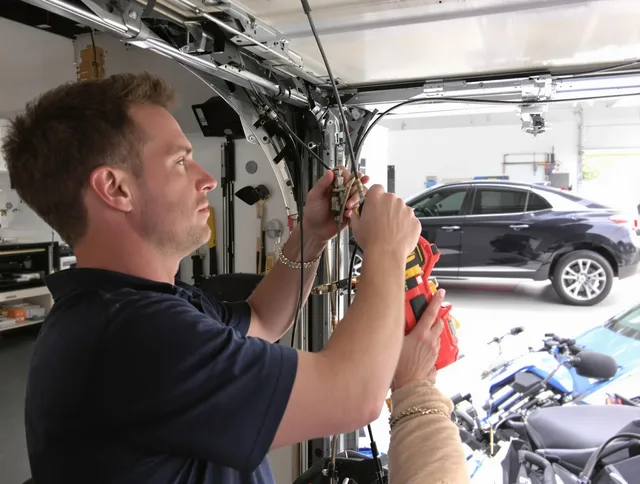 Copley Garage Door Repair safety certified technician performing cable replacement in Copley